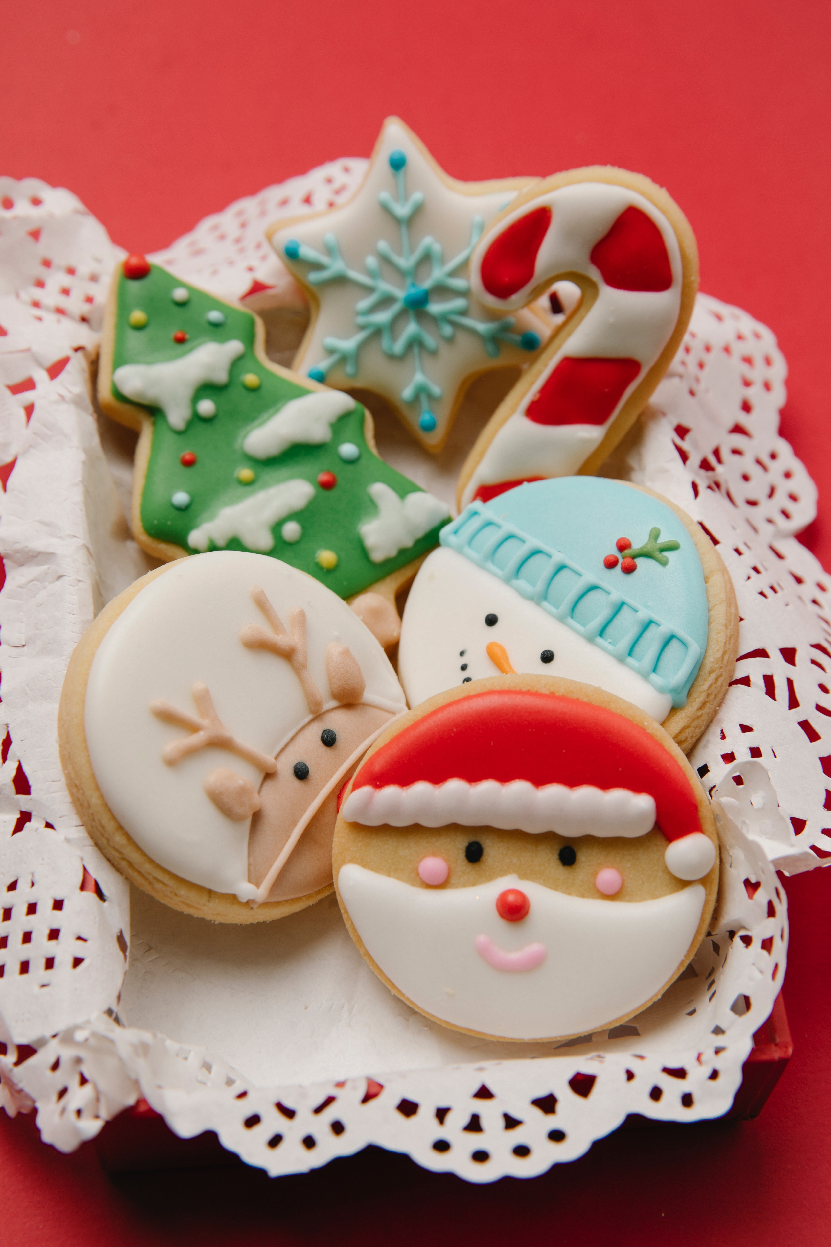 Decorated Christmas cookies on lace-trimmed tray.