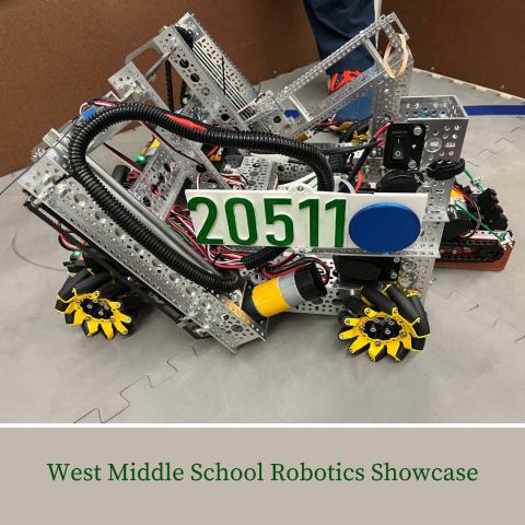 silver robotics competition robot of metal plates, wires and yellow wheels