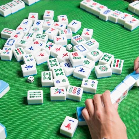 mahjong tiles on a green table