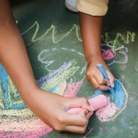 Outdoor fun, children doing chalk