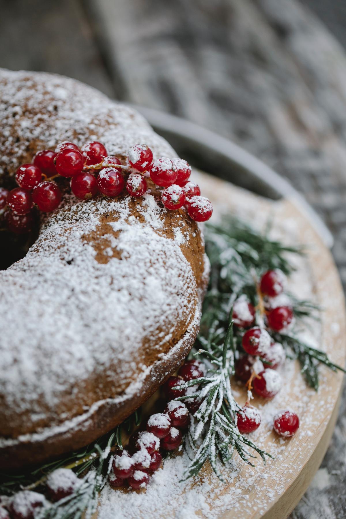 Holiday cake with sugar-frosted berries on top.