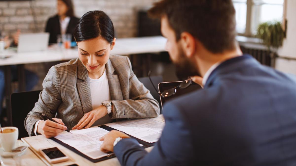 two business people review paperwork together