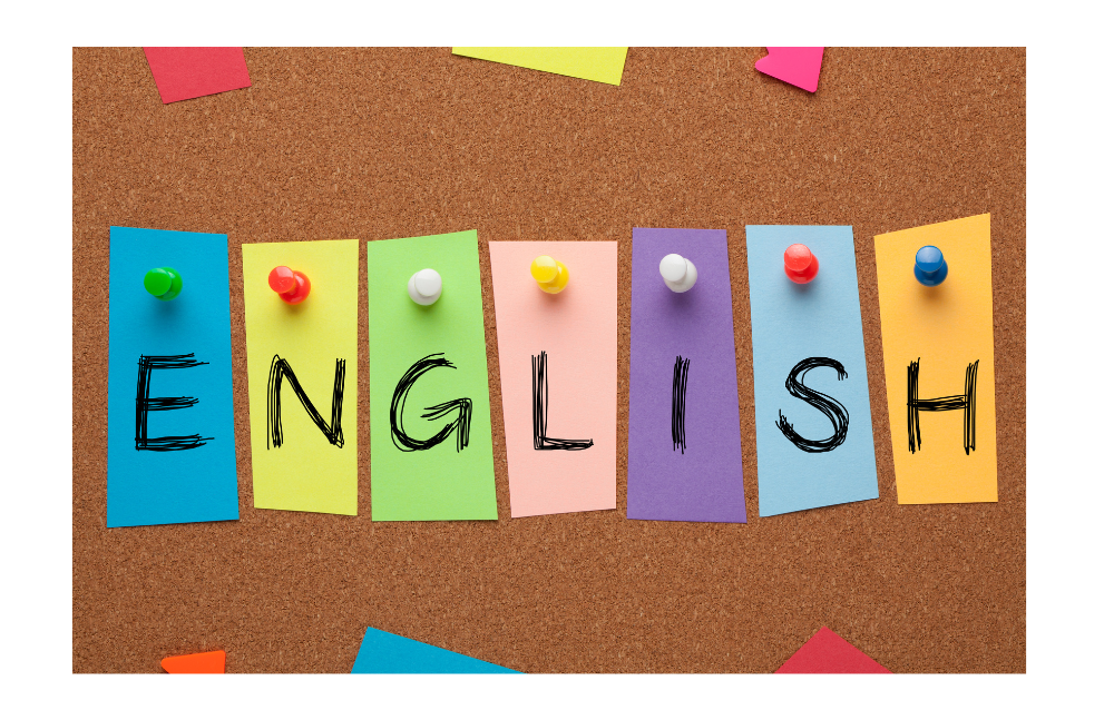 The word "English" is spelled out on small colorful pieces of paper pinned to a bulletin board. 