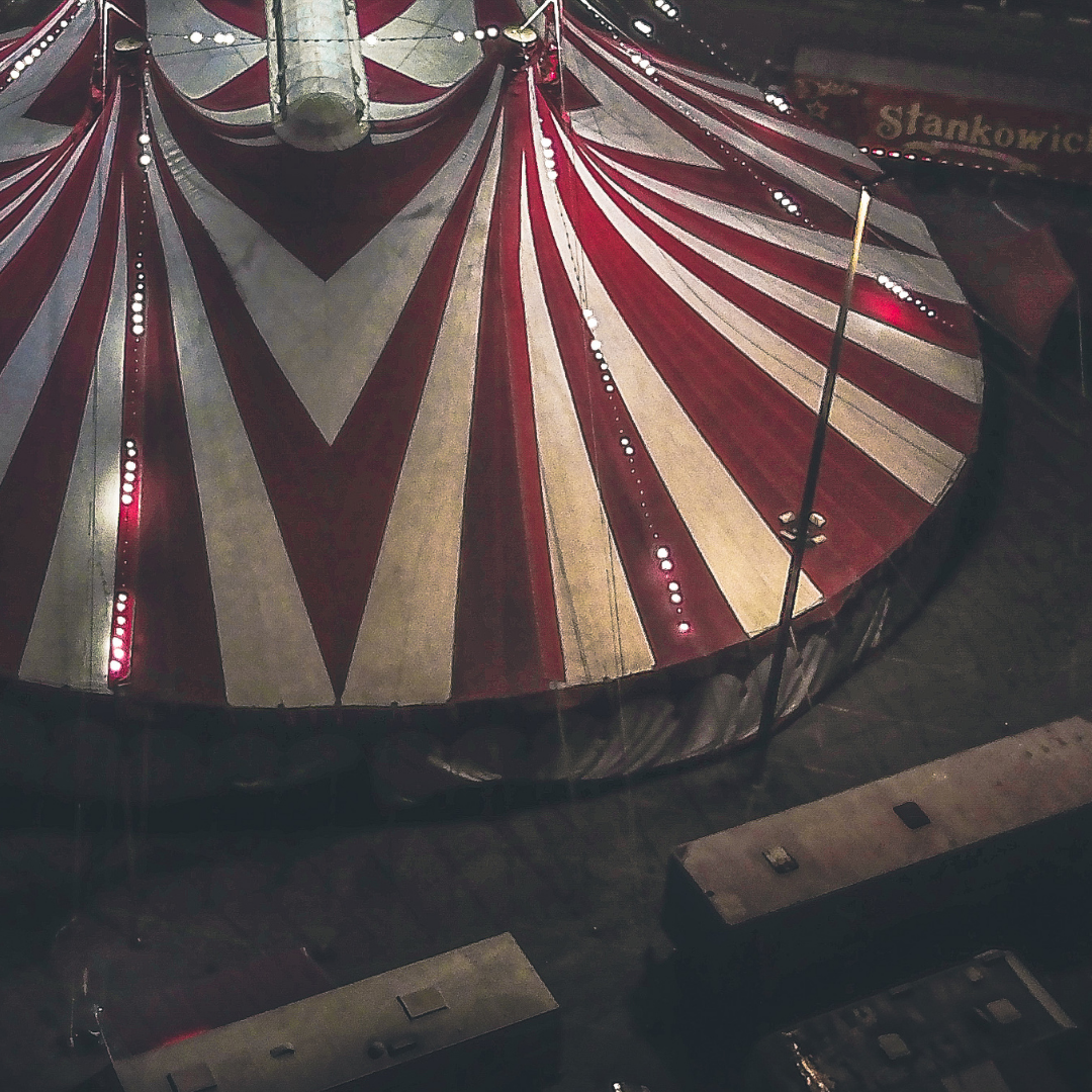 A dark image of a circus big-top tent