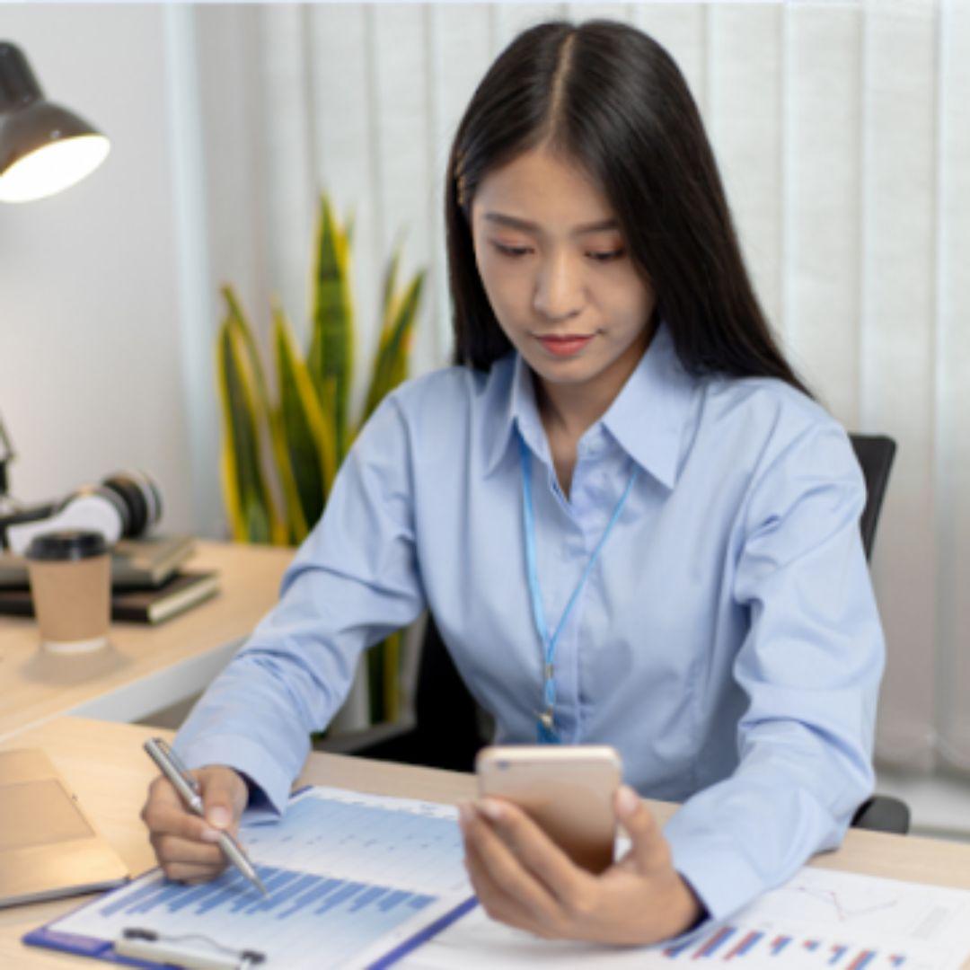 woman with calculator looks at financial report