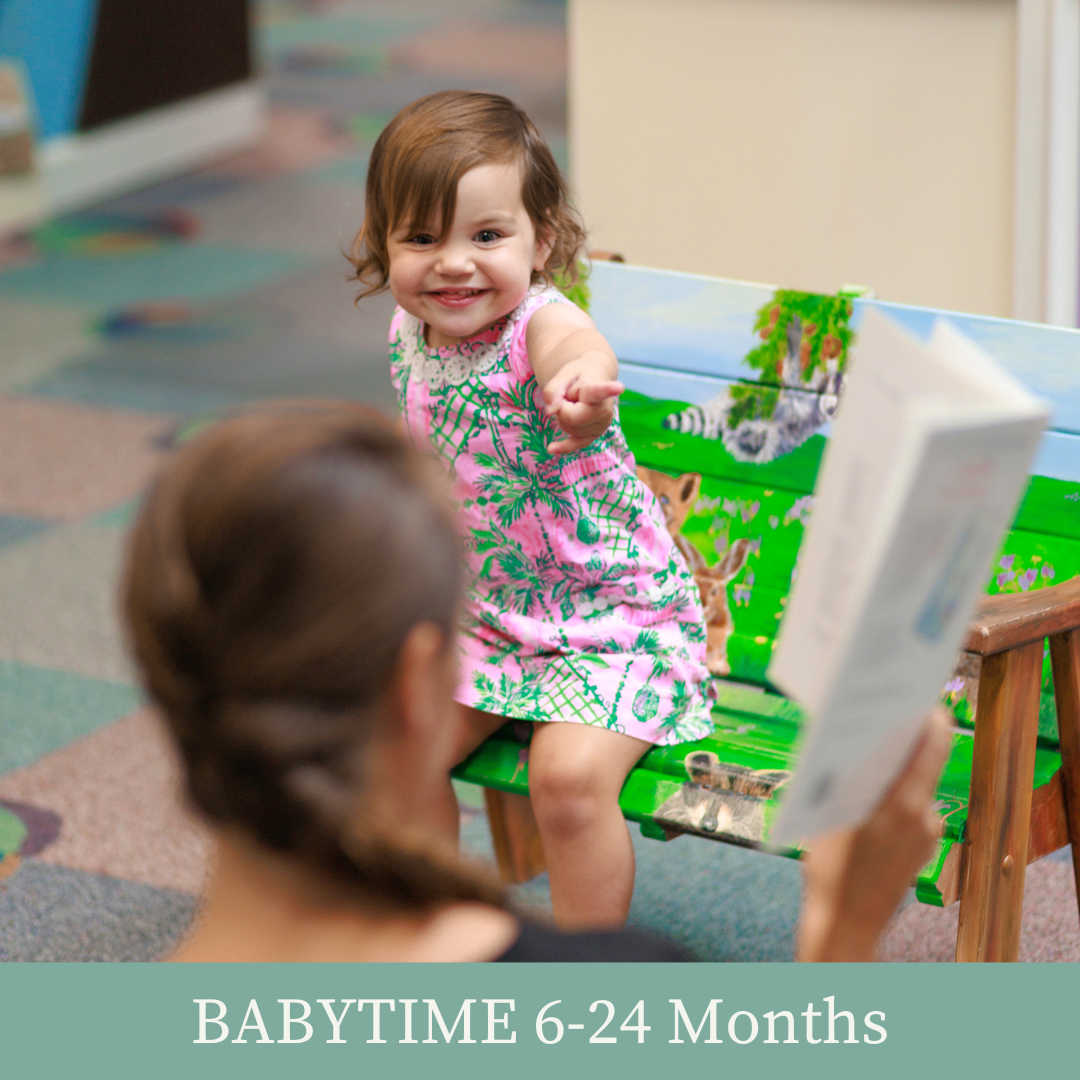 Grown up reading a book to a toddler