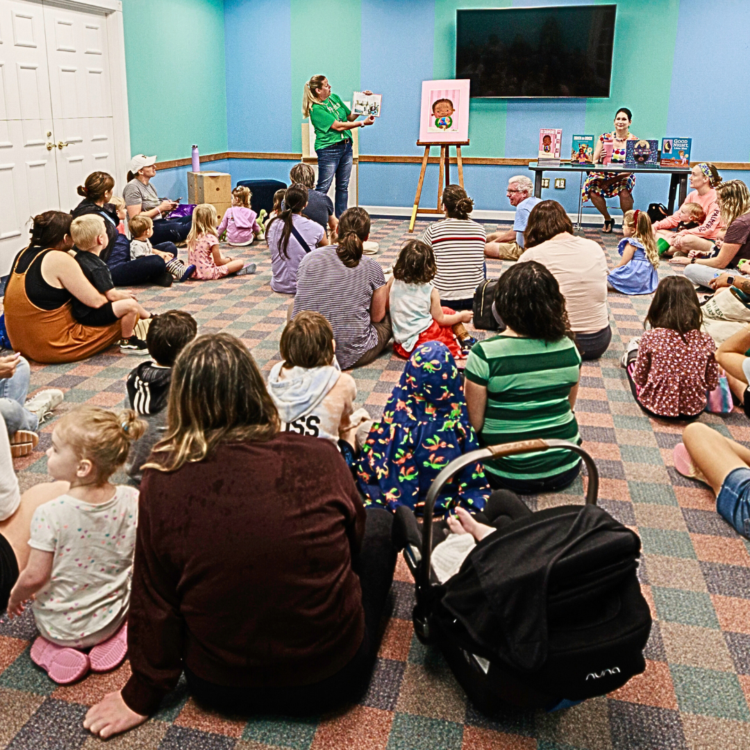 families watching a librarian read a book out loud